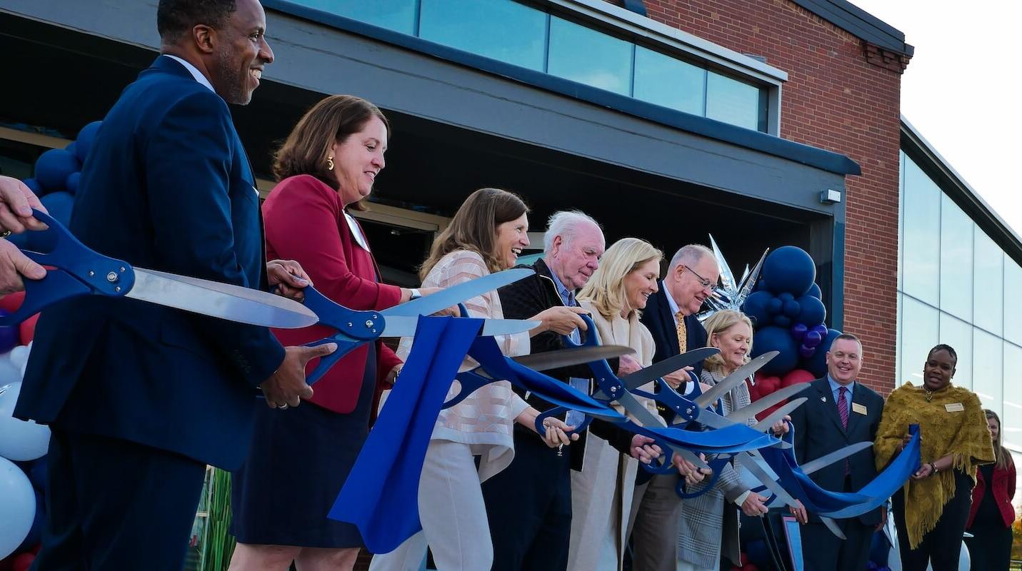 Shenandoah University officials; Cecil Pruitt, Jr.; and members of the Hazel family cut a ribbon to celebrate the opening of Hazel-Pruitt Armory.